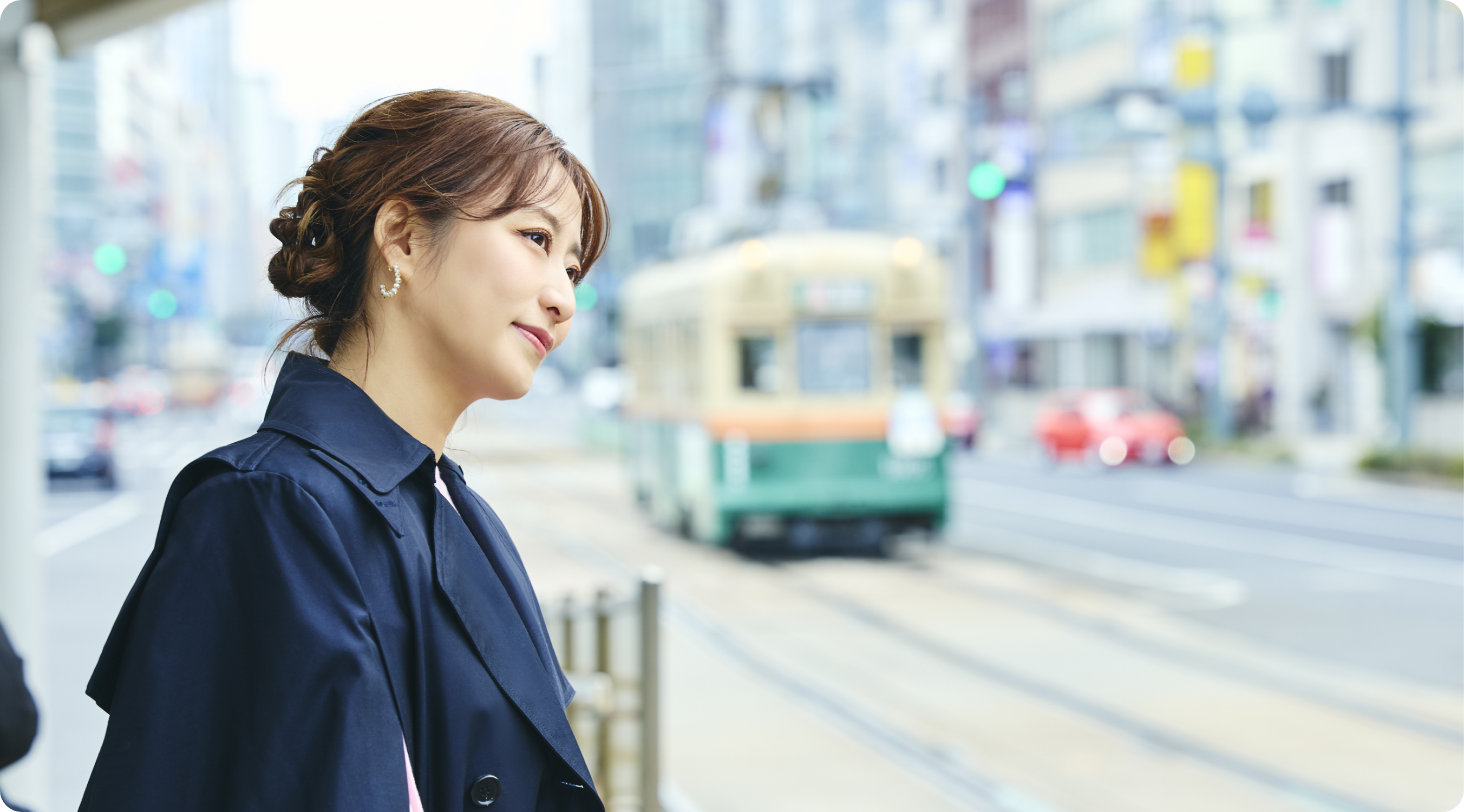 �L���s�X�𑖂�H�ʓd�Ԃ�w�i�ɁA�w���ӂ̌i�F�����߂�e�c�G���ނ���